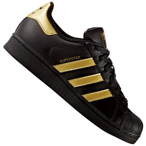 Schwarze, goldene adidas Superstar 